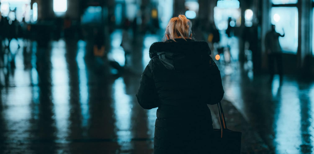 blonde-woman-coat-standing-street-night